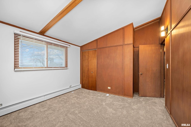 unfurnished bedroom with vaulted ceiling with beams, light colored carpet, a closet, and a baseboard heating unit