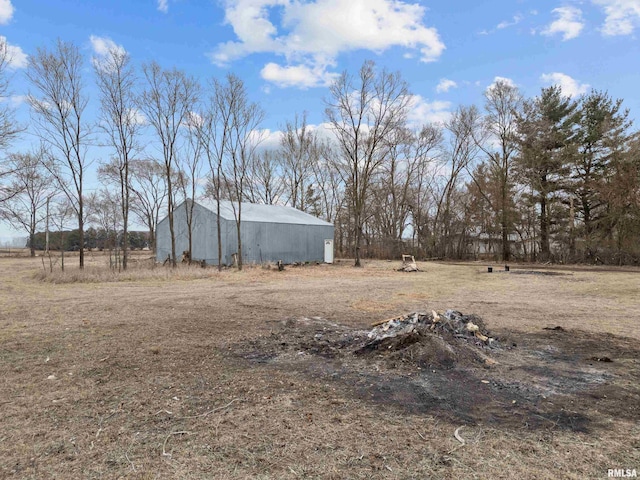 view of yard featuring a rural view and an outbuilding