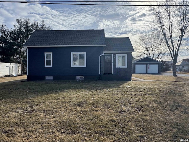 view of front of home with a garage, an outdoor structure, and a front yard