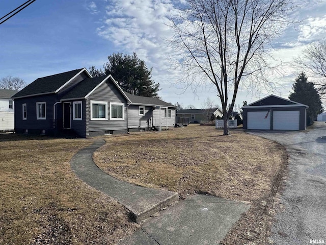 view of home's exterior with a garage, an outdoor structure, and a lawn