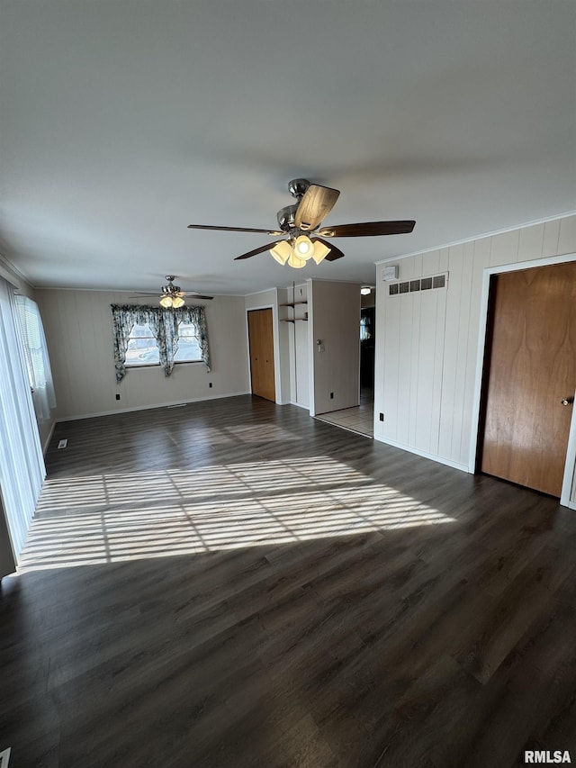 interior space featuring dark wood-type flooring and ceiling fan