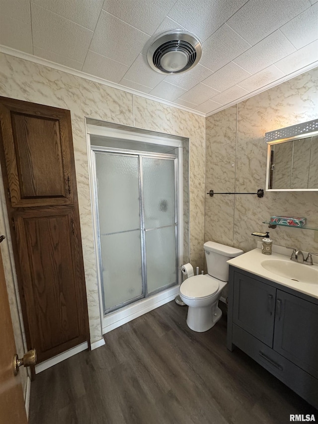 bathroom featuring vanity, toilet, hardwood / wood-style floors, and a shower with shower door