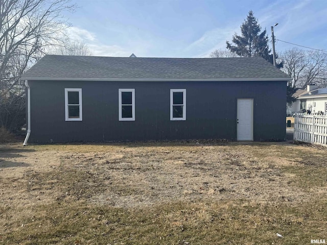 view of side of property with a lawn