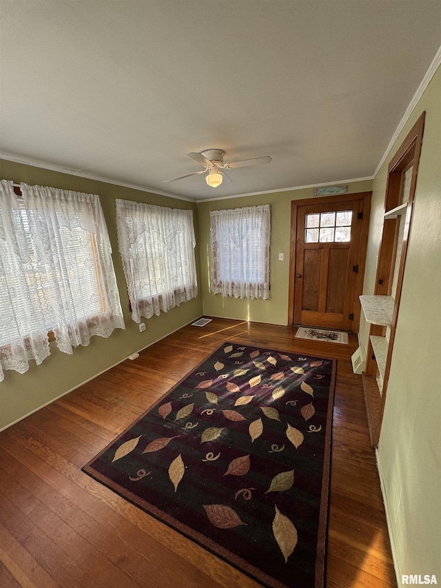 entryway featuring crown molding, dark wood-type flooring, and ceiling fan