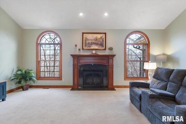 living room featuring a wealth of natural light and light colored carpet