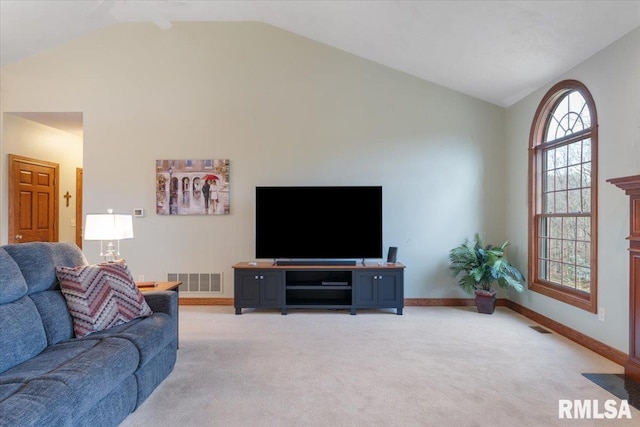 carpeted living room featuring high vaulted ceiling