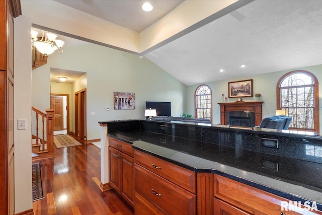 kitchen with lofted ceiling with beams and dark hardwood / wood-style floors