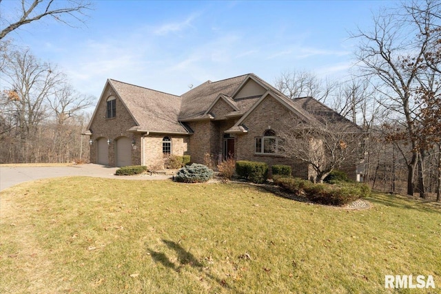 view of front of home with a garage and a front lawn