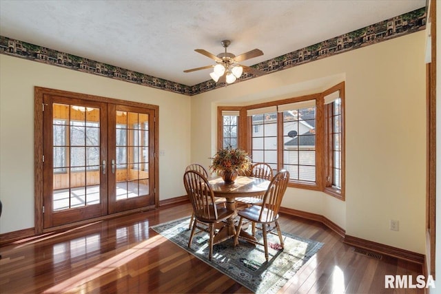 dining room with a wealth of natural light, french doors, and wood-type flooring