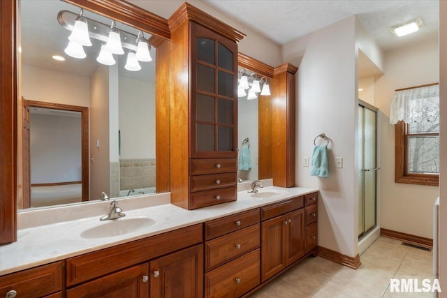 bathroom with vanity, tile patterned floors, and shower with separate bathtub