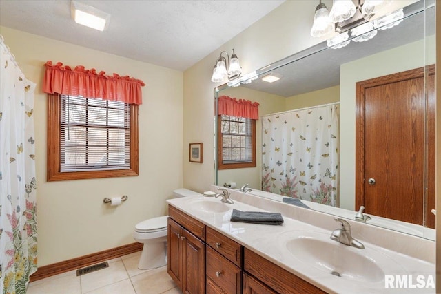 bathroom with tile patterned flooring, vanity, a shower with curtain, and toilet