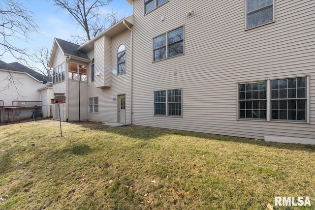 rear view of property with a lawn