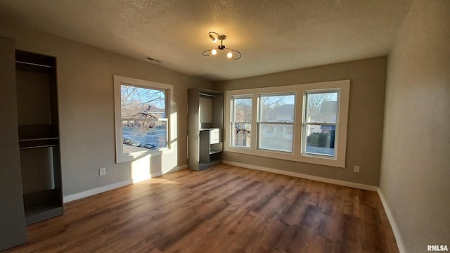 822 6th Ave S, Clinton, IA 52732 - unfurnished room with hardwood / wood-style floors and a textured ceiling