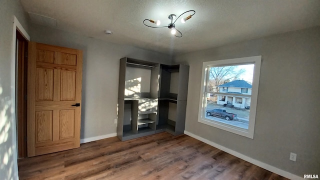 822 6th Ave S, Clinton, IA 52732 - unfurnished room with hardwood / wood-style flooring and a textured ceiling