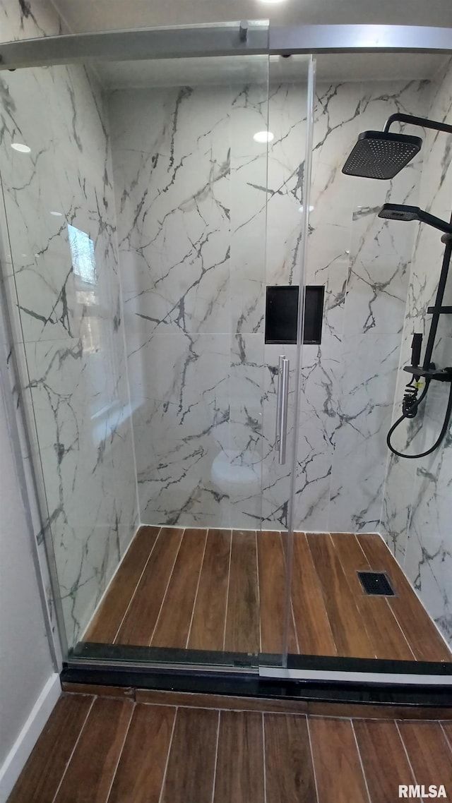 822 6th Ave S, Clinton, IA 52732 - bathroom featuring hardwood / wood-style flooring and a shower with door