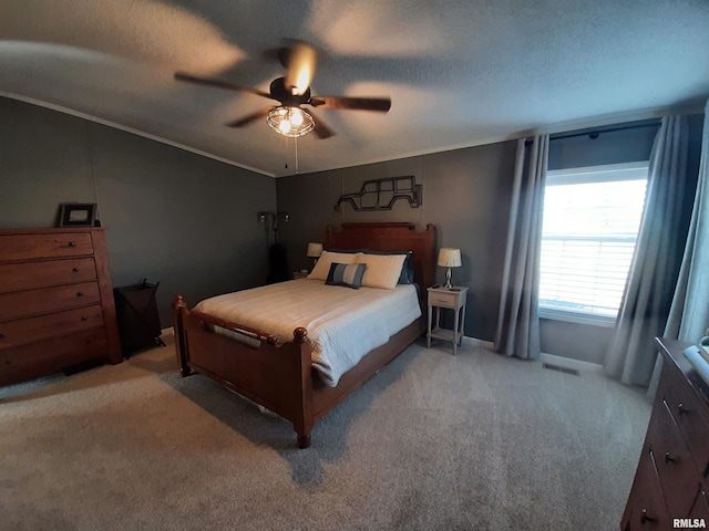 carpeted bedroom with crown molding, ceiling fan, and a textured ceiling