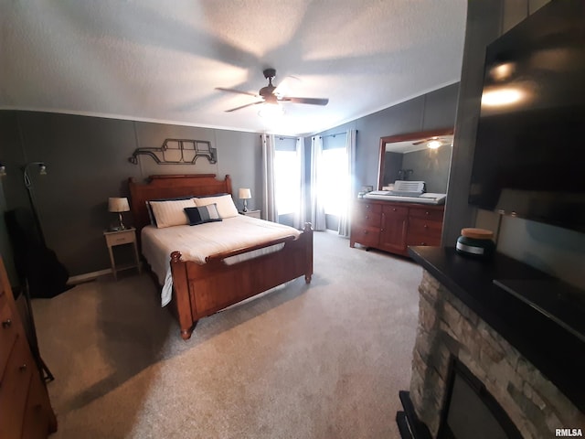 carpeted bedroom with ornamental molding, ceiling fan, a fireplace, and a textured ceiling