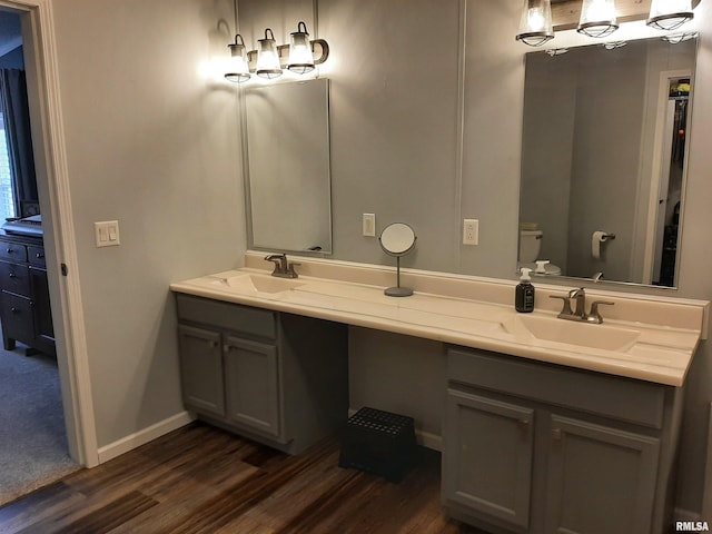 bathroom with hardwood / wood-style flooring, vanity, and toilet