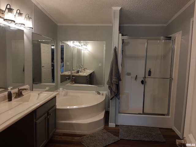 bathroom with ornamental molding, shower with separate bathtub, and hardwood / wood-style floors