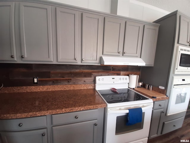 kitchen featuring gray cabinets and white appliances