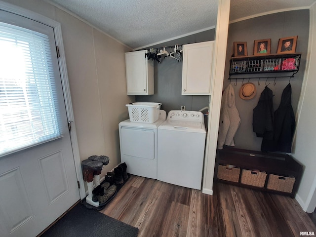 clothes washing area with cabinets, a textured ceiling, ornamental molding, dark hardwood / wood-style floors, and washer and clothes dryer