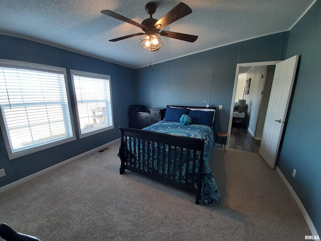 bedroom featuring ceiling fan, carpet, and a textured ceiling