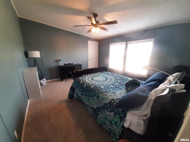 bedroom featuring light carpet, ceiling fan, lofted ceiling, and a textured ceiling