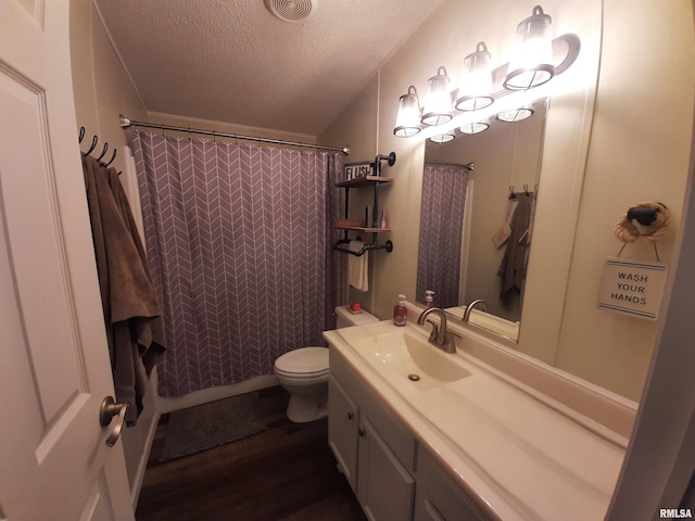 bathroom with vanity, hardwood / wood-style floors, toilet, and a textured ceiling