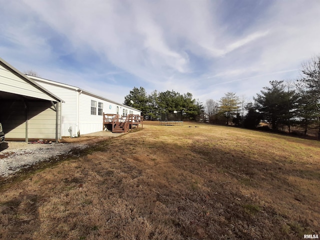 view of yard featuring a wooden deck