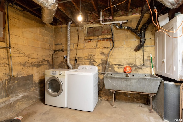 clothes washing area with sink and washer and clothes dryer