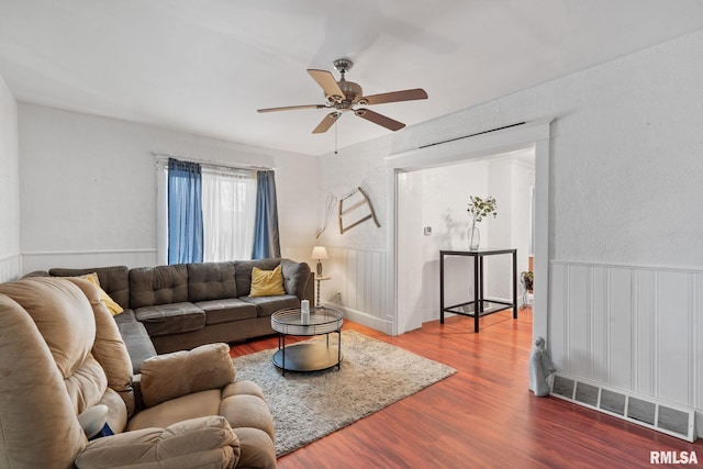 living room with ceiling fan and hardwood / wood-style floors