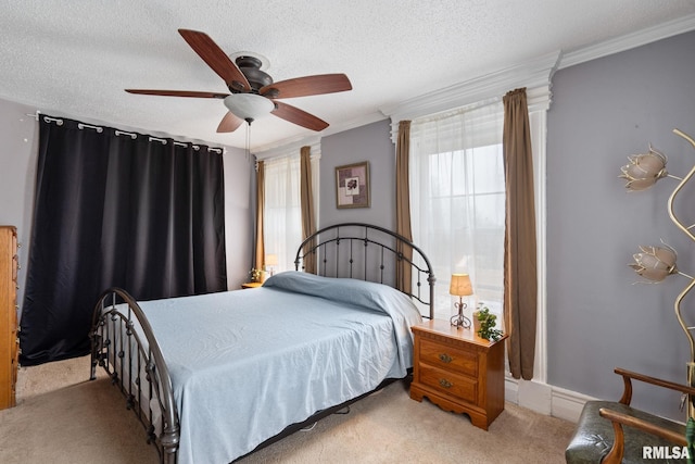 bedroom featuring crown molding, light colored carpet, ceiling fan, and a textured ceiling