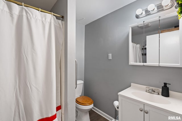 bathroom featuring vanity, toilet, curtained shower, and hardwood / wood-style floors