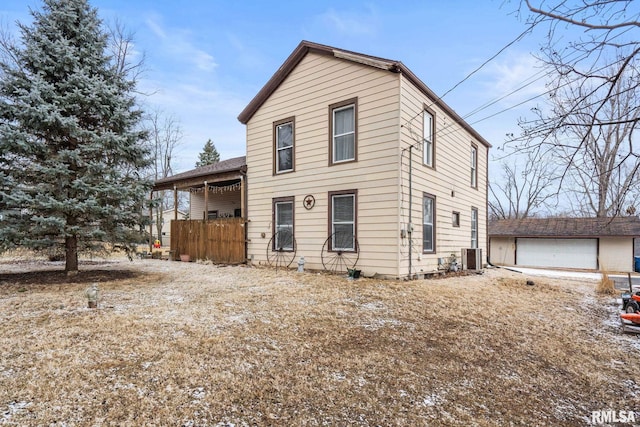 view of front property with a garage, an outdoor structure, and central AC unit