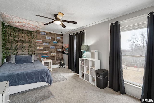 bedroom with multiple windows, crown molding, carpet floors, and a textured ceiling