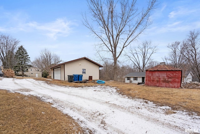 exterior space featuring an outbuilding and a garage