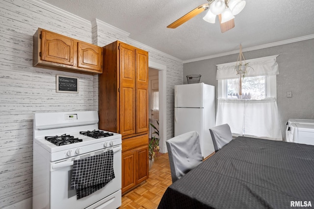 kitchen with white appliances, ceiling fan, light parquet floors, ornamental molding, and a textured ceiling