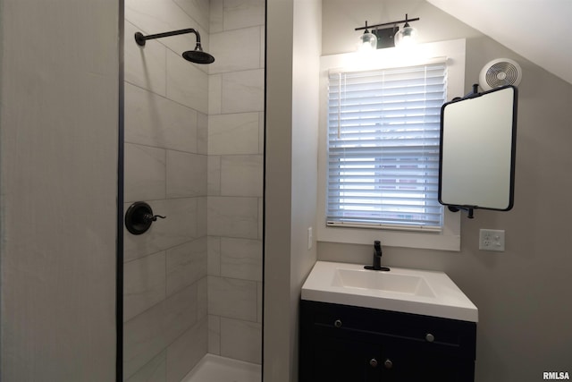 bathroom featuring vanity and tiled shower