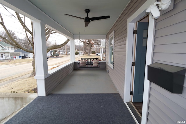 view of patio featuring ceiling fan and a porch