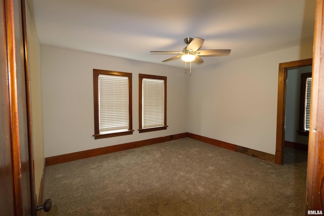 unfurnished room featuring dark carpet and ceiling fan