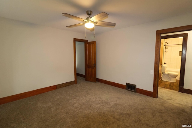 unfurnished bedroom with ceiling fan, ensuite bath, and carpet