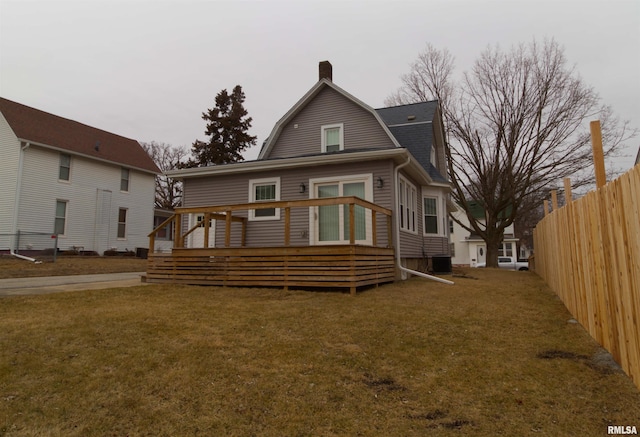 back of house with cooling unit and a lawn