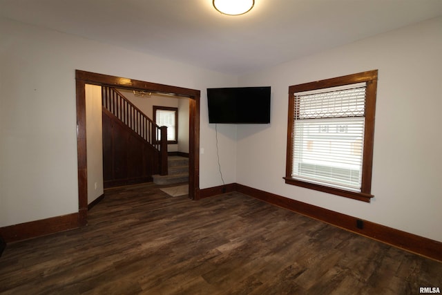 empty room with dark hardwood / wood-style flooring