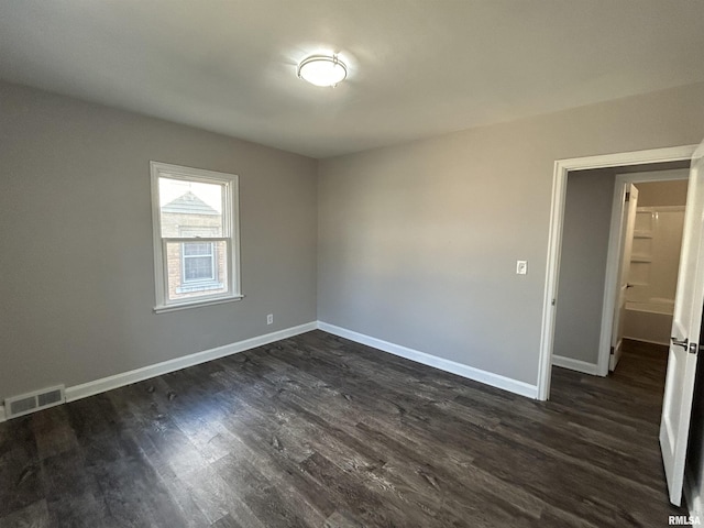 unfurnished room with dark hardwood / wood-style flooring