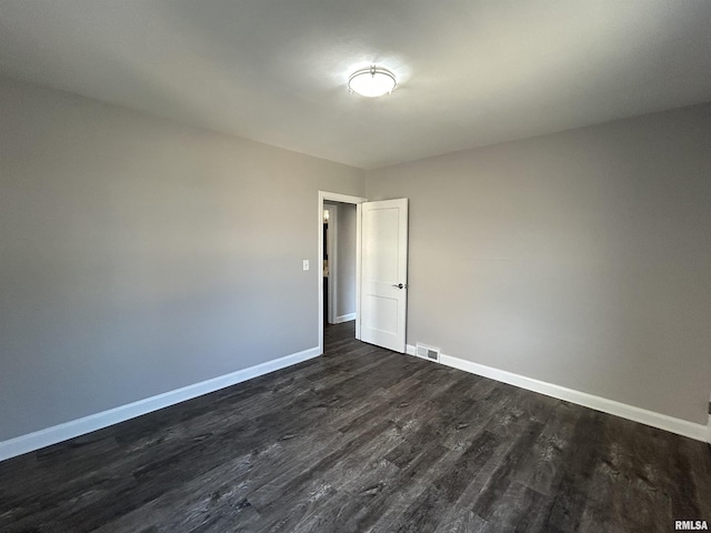 empty room featuring dark hardwood / wood-style flooring