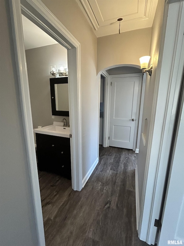 corridor featuring dark hardwood / wood-style flooring and sink