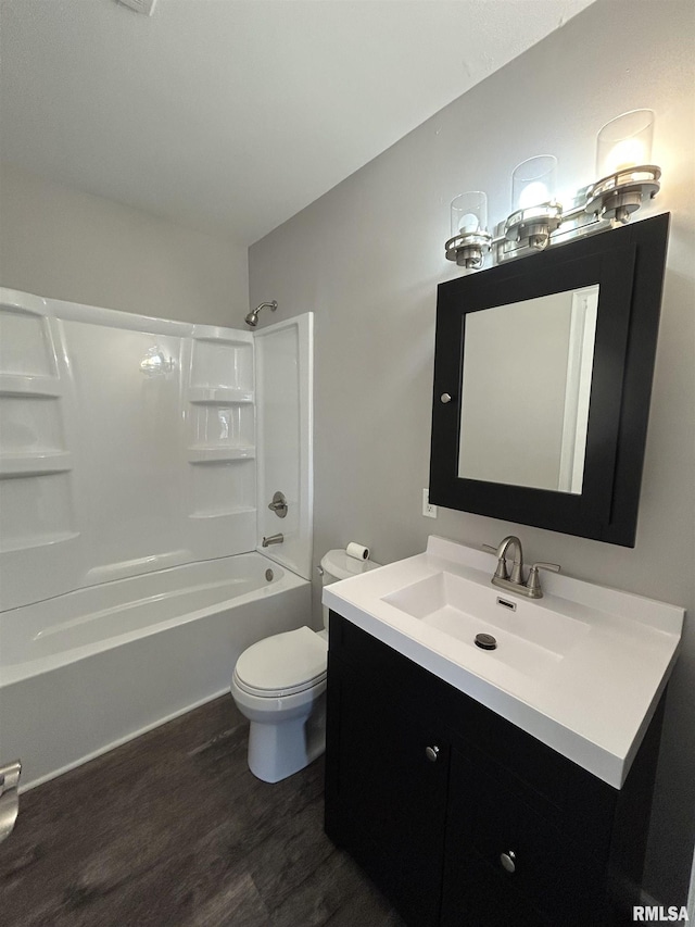 full bathroom featuring hardwood / wood-style flooring, toilet, vanity, and  shower combination