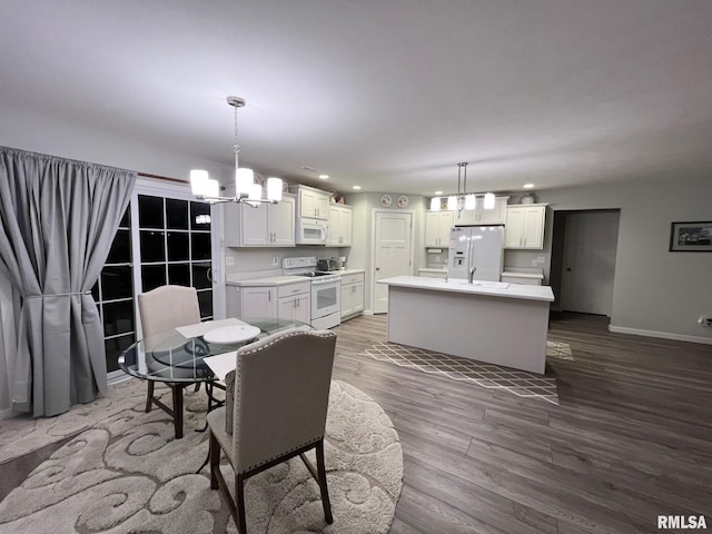 dining space featuring a notable chandelier and dark hardwood / wood-style floors