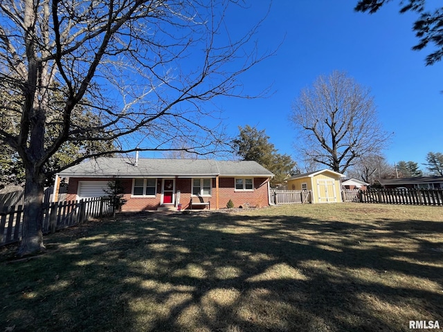 rear view of house featuring a storage shed and a yard