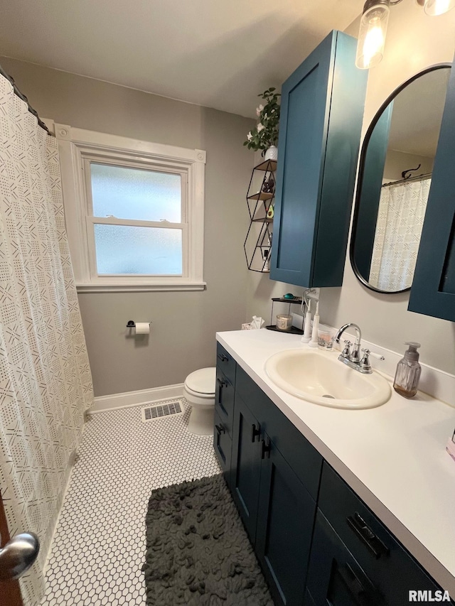 bathroom with tile patterned floors, vanity, and toilet